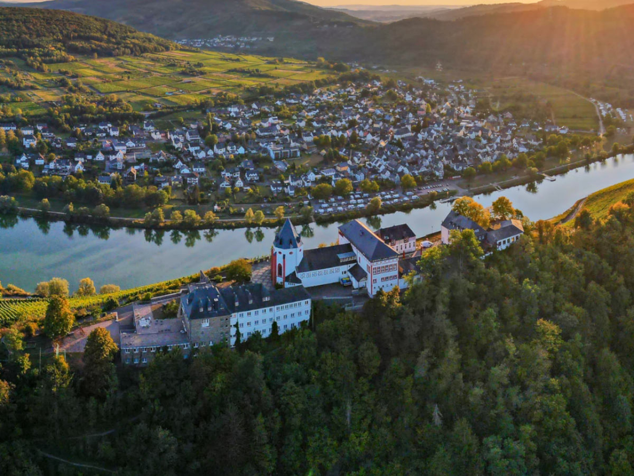 Luftaufnahme der Marienburg in Zell mit Pünderich an der Mosel im Hintergrund.