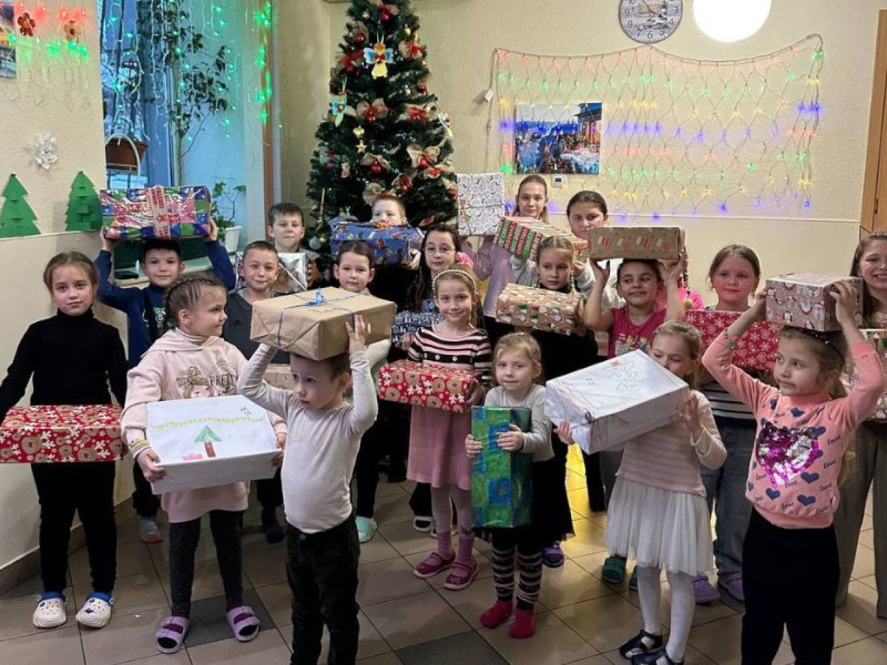 Gruppenfoto von ukrainischen Kindern mit Geschenkpaketen.